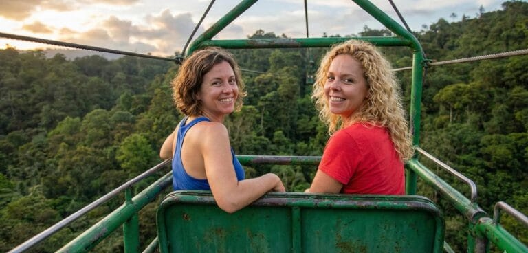 Two women enjoying rainforest cable car ride