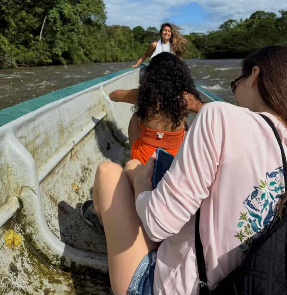 Friends enjoying boat ride on tropical river
