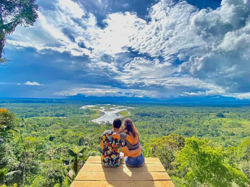 Couple admiring vast jungle and winding river view