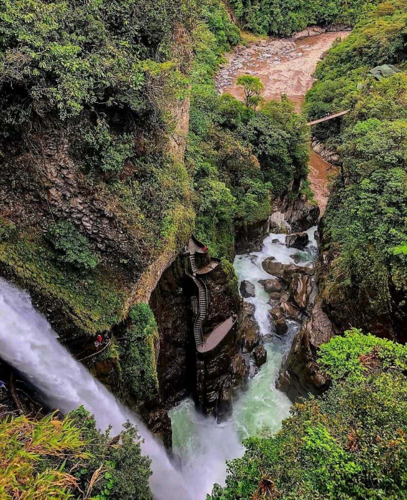 Waterfall flowing through lush green canyon rocks