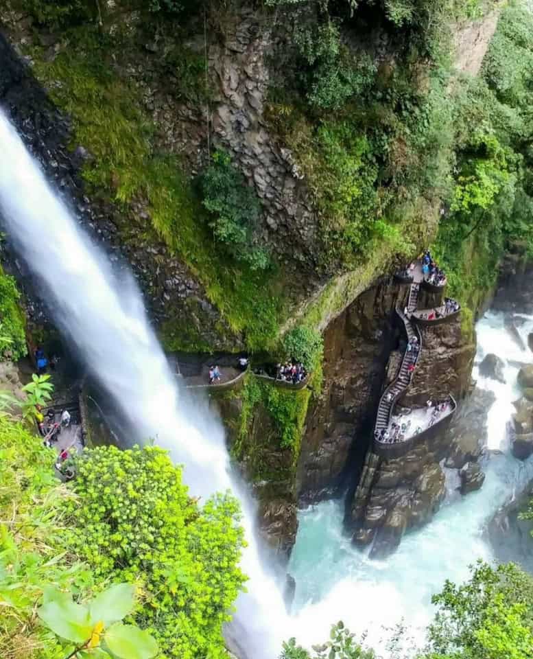 Waterfall with rocky cliffs and scenic walkway