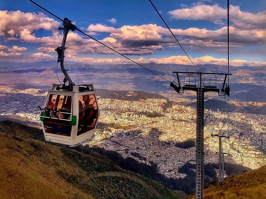 Cable car over city and mountains at sunset