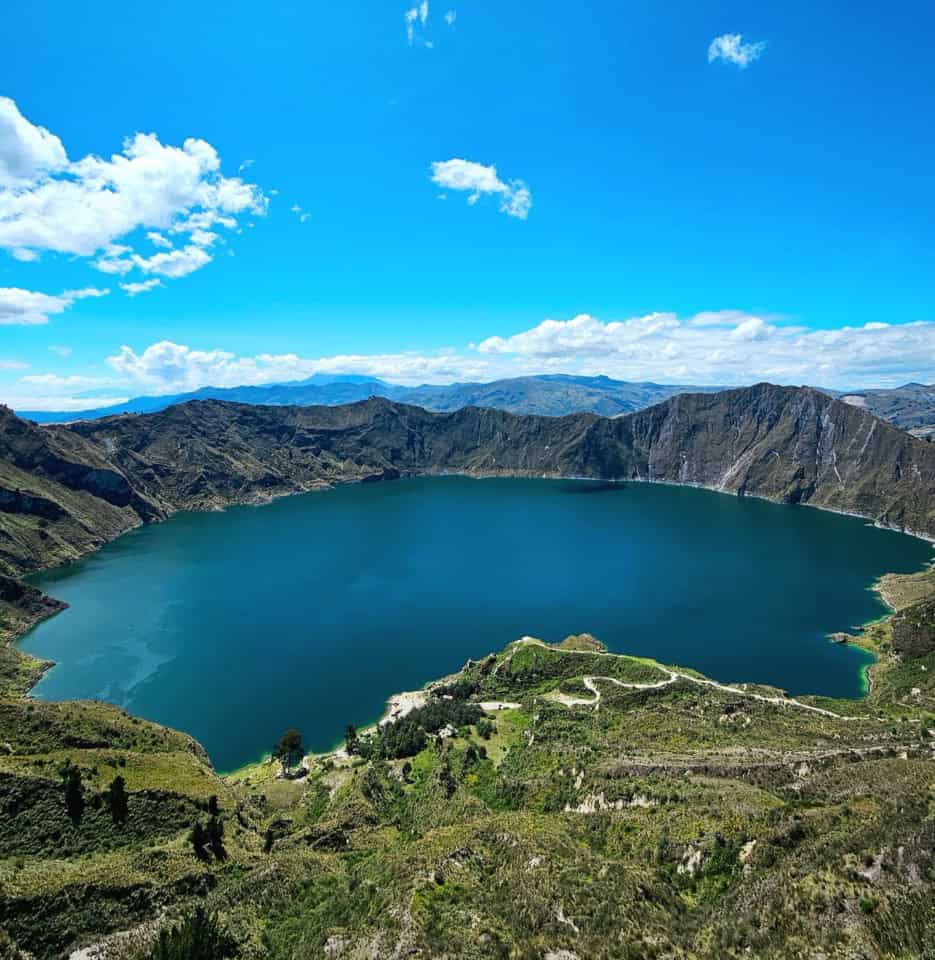 Blue crater lake surrounded by green mountains