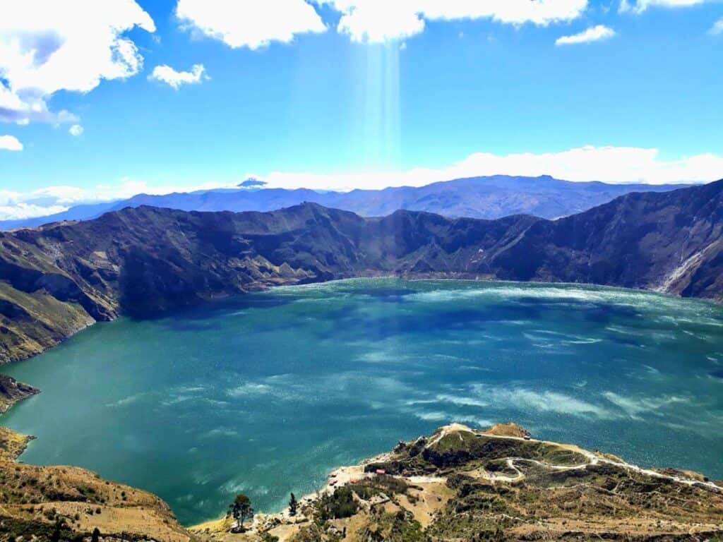 Blue crater lake surrounded by green mountains