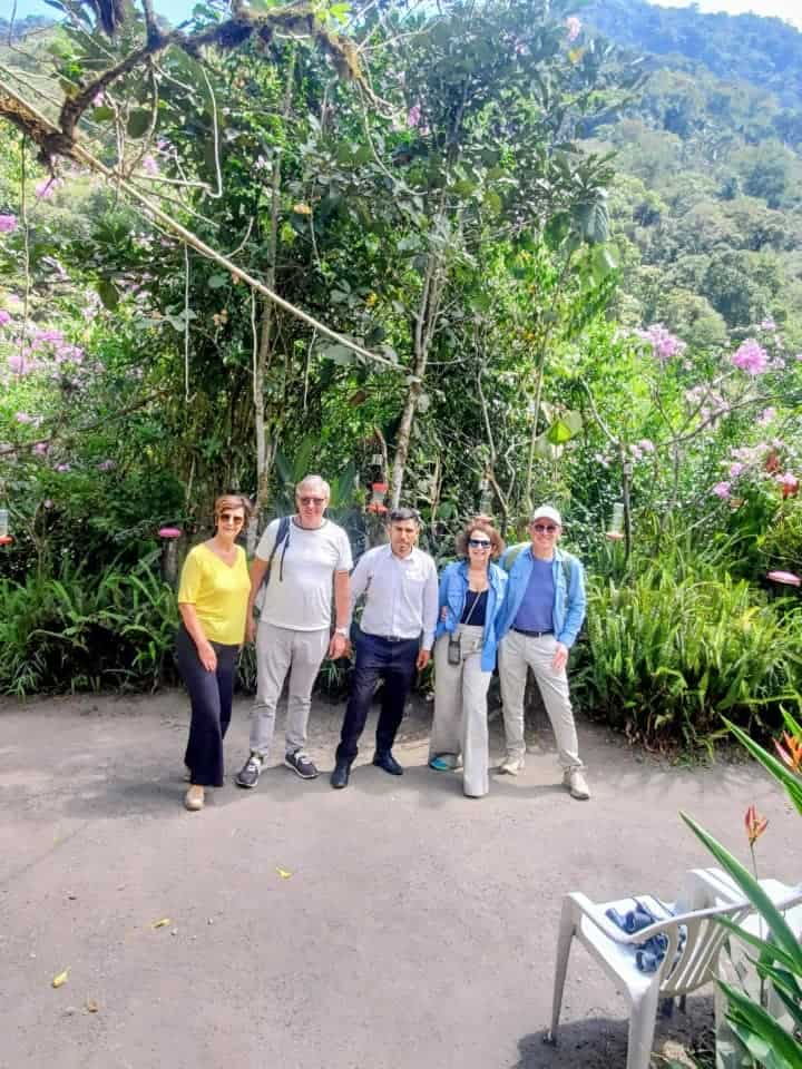 Group of people standing in lush tropical garden