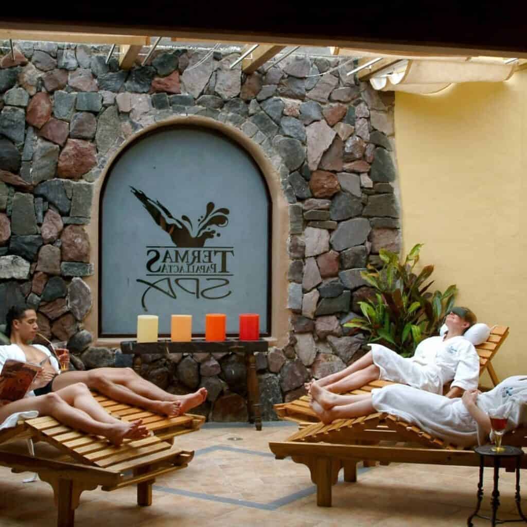 People relaxing on loungers at spa retreat