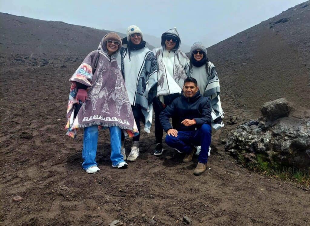 Group wearing ponchos on a volcanic mountain hike