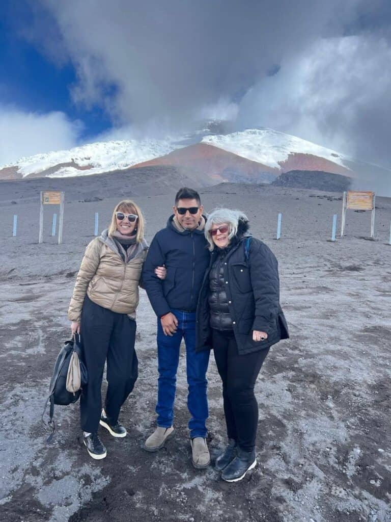 Group standing on snowy mountain slope outdoors